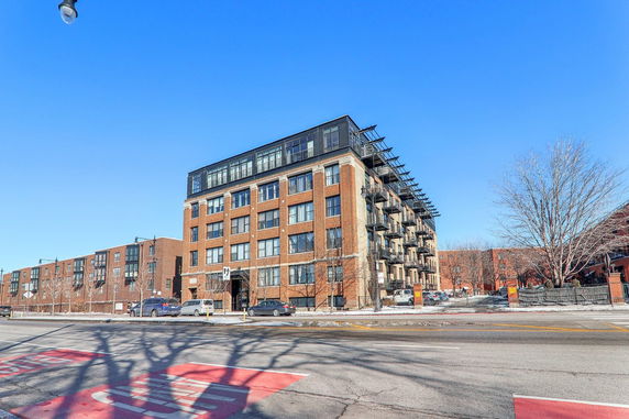 Front view of a multi-story brick apartment building.