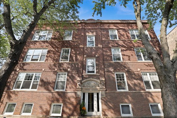 Front view of a multi-story brick apartment building.