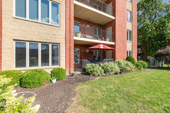 Front view of a multi-story apartment building with balconies.