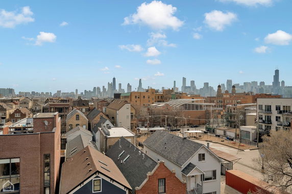 Panoramic view of a cityscape with residential and commercial buildings.