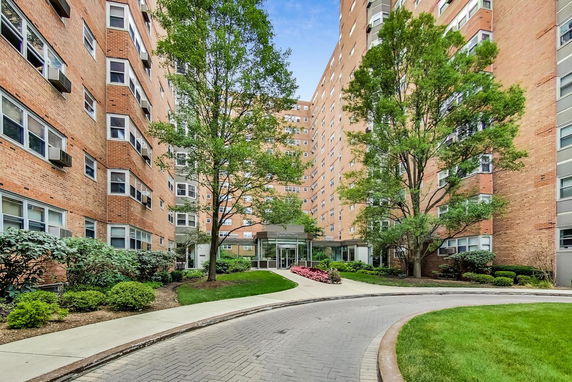Front view of a multi-story brick apartment building.