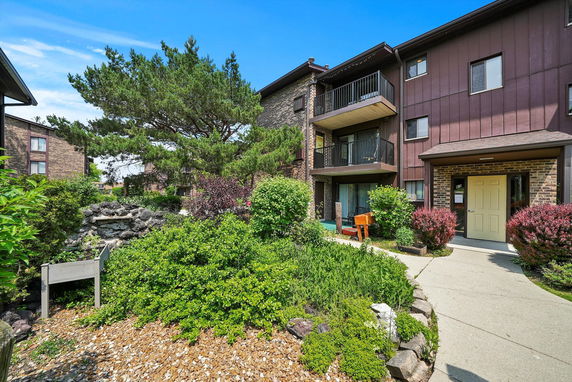 Front view of a multi-story residential building with balconies.