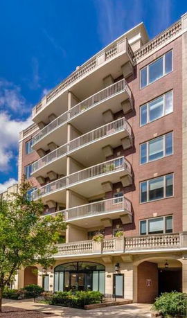 Front view of a multi-story building with balconies.