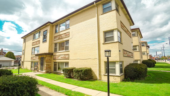 Front view of a three-story brick apartment building.