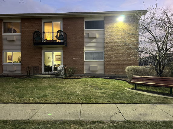 Front view of a two-story brick building with balconies.