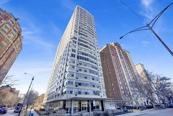 Front view of a tall residential building with multiple stories.