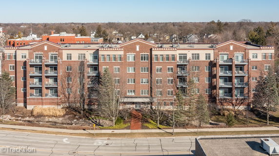 Front view of a multi-story brick building with balconies.