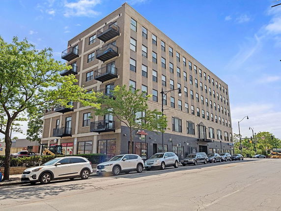 Front view of a multi-story building with balconies.