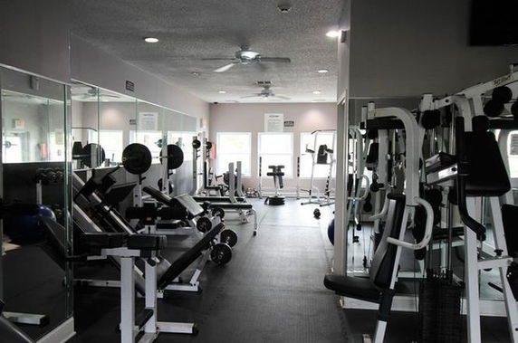 Interior view of a gym area with various exercise equipment.