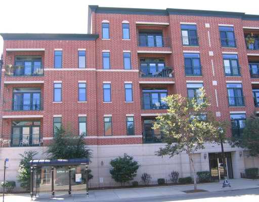Front view of a multi-story brick building with balconies.