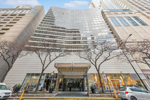 Front view of a large multi-story commercial building with glass facade.