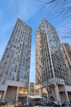 Front view of two tall residential buildings with multiple windows.