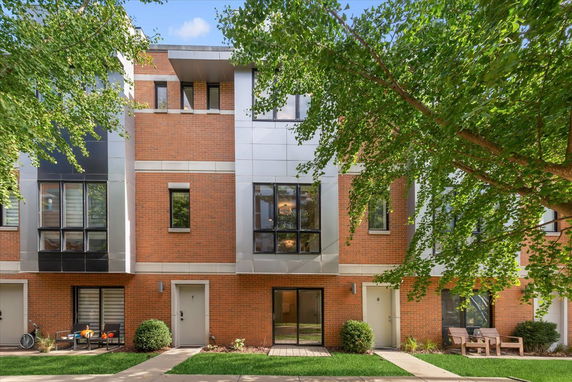 Front view of a modern multi-story building with brick and metal facade.