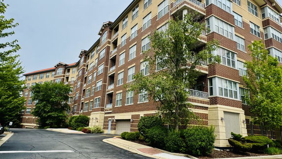 Front view of a multi-story apartment building with brick exterior.