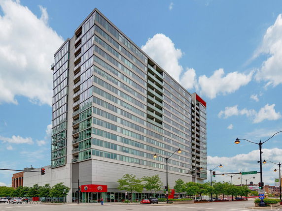 Front view of a multi-story building with large windows and a modern design.