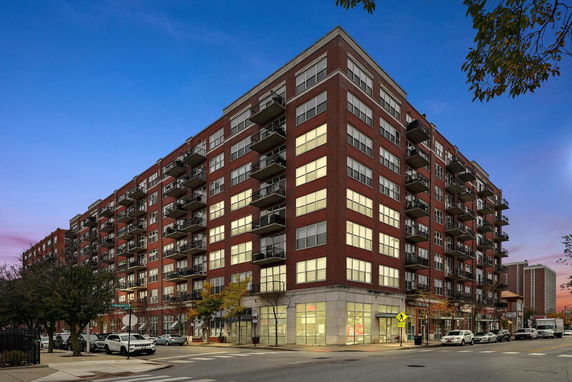 Front view of a multi-story apartment building with balconies.