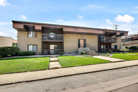 Front view of a two-story apartment building with balconies.