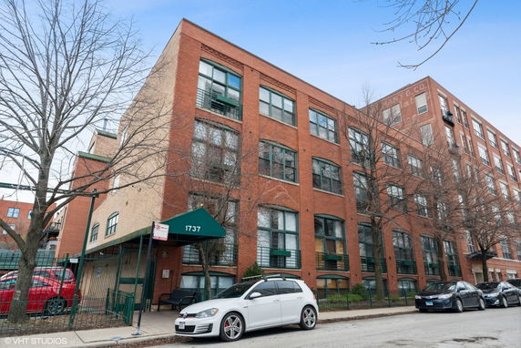 Front view of a multi-story brick apartment building.
