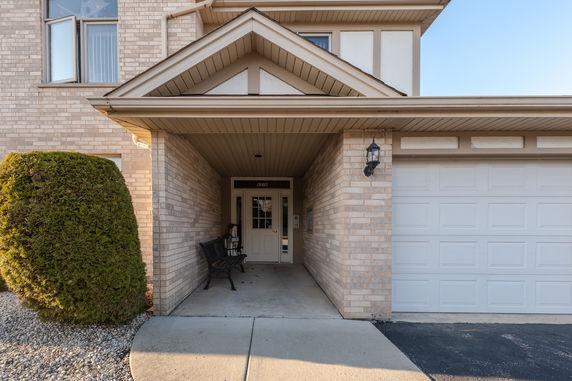 Front view of a house with a covered entrance and attached garage.