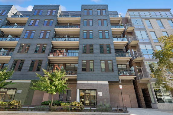 Front view of a multi-story apartment building with balconies.