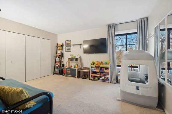 Indoor children's play area with toys and a small playhouse.
