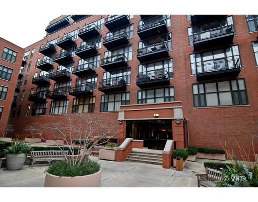 Front view of a multi-story brick building with balconies.
