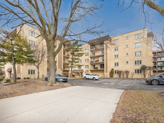 Front view of a multi-story apartment building with balconies.