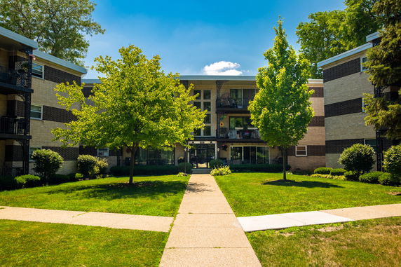 Front view of a multi-story apartment building with balconies.