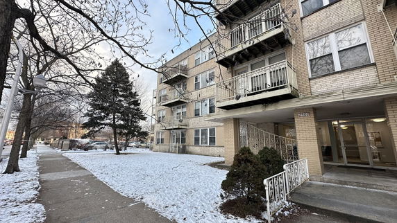 Front view of a multi-story residential building with balconies.