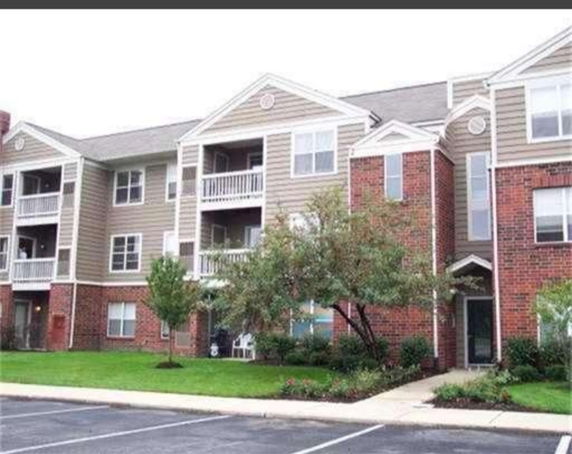 Front view of a three-story residential building with balconies.