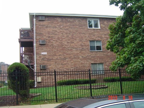 Side view of a multi-story brick apartment building