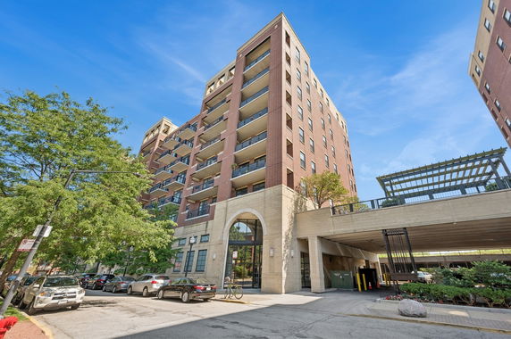 Front view of a multi-story residential building with balconies.