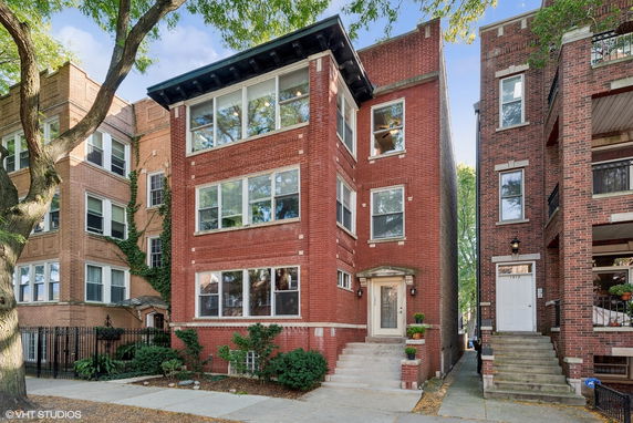 Front view of a three-story brick apartment building.