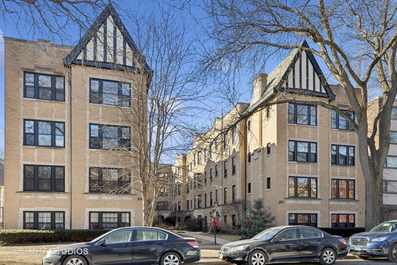 Front view of a multi-story residential building with a Tudor-style facade.