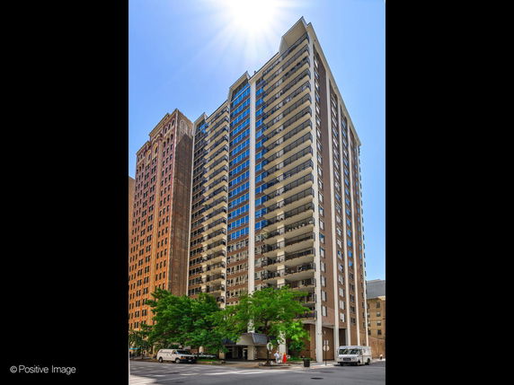 Front view of a high-rise building with multiple balconies.