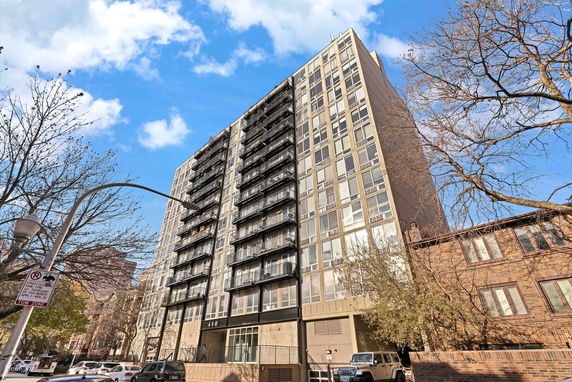 Front view of a multi-story residential building with balconies.