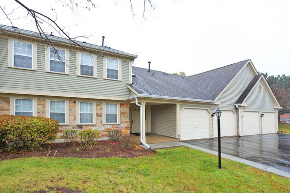 Front view of a two-story house with attached garages.