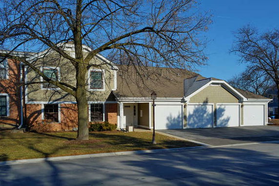 Front view of a two-story house with a double garage and a single garage.