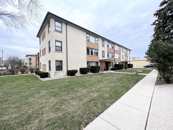 Front view of a two-story residential building with brick facade.