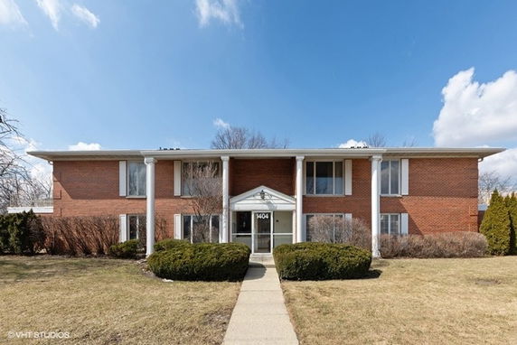 Front view of a two-story brick building with white columns.