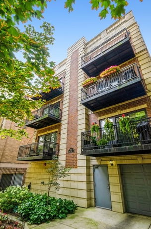 Front view of a multi-story residential building with balconies.