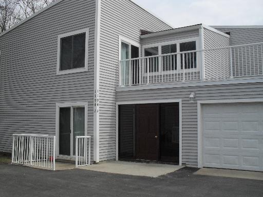 Front view of a two-story house with siding and a double garage.