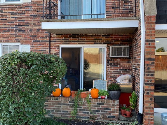 Front view of a brick building with a small balcony.