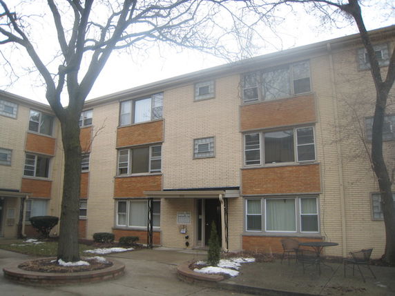 Front view of a three-story brick apartment building.