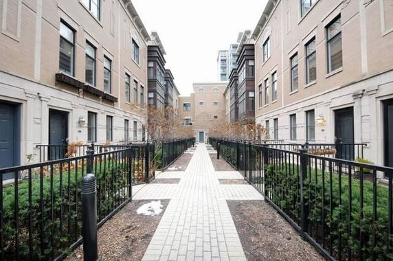 Front view of a row of townhouses with similar architecture.