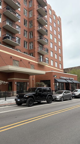 Front view of a multi-story building with balconies.