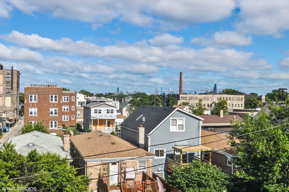 Panoramic view of residential neighborhood with various houses and buildings.