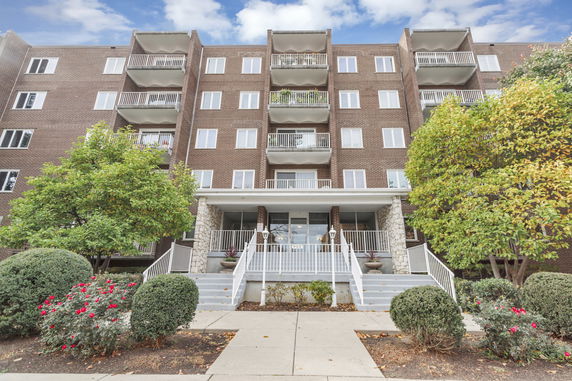 Front view of a multi-story building with balconies.