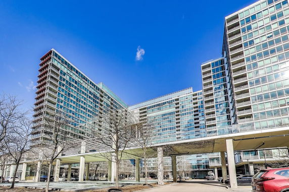 Front view of a modern multi-story glass building.