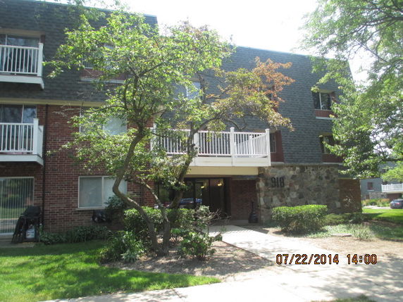 Front view of a multi-story residential building with balconies.